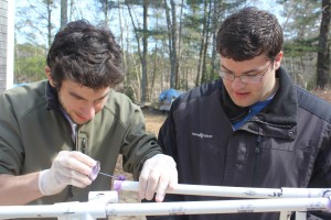 Alex and Brett work to glue together the new bow section