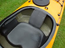 A composite sea kayak featuring a molded seat pan and custom-shaped back support.
