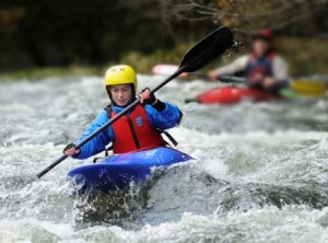 Paddling through the rapids with strong forward strokes